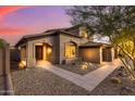 Two-story home with arched entryway and walkway leading to the front door at 14035 E Sahuaro Dr, Scottsdale, AZ 85259