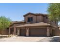 Two-story house with a two-car garage and desert landscaping at 14035 E Sahuaro Dr, Scottsdale, AZ 85259