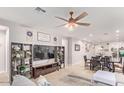 Living room features a large TV and built-in shelving at 17536 W Desert Bloom St, Goodyear, AZ 85338