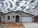 New construction home featuring a two-car garage and neutral exterior at 19449 W Valle Vista Way, Litchfield Park, AZ 85340