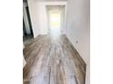 Bright hallway with wood-look tile flooring leading to other rooms at 19449 W Valle Vista Way, Litchfield Park, AZ 85340