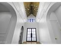 Grand foyer featuring a striking chandelier, vaulted wood ceiling, and elegant double doors at 19912 E Karsten Dr, Queen Creek, AZ 85142