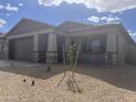 Charming single-story home with neutral paint, rock accents, and a well-kept xeriscaped yard at 20622 N 226Th Ln, Surprise, AZ 85387