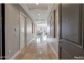 Bright hallway with tile floors leading to living areas at 2211 E Camelback Rd # 1202, Phoenix, AZ 85016