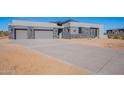 Contemporary home with large driveway and desert landscaping at 25580 N 119Th St, Scottsdale, AZ 85255