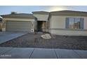Single-story home with two-car garage and desert landscaping at 4072 S Skyline Ct, Gilbert, AZ 85297