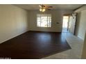 Living room with dark hardwood floors and tile accents at 5019 W Roma Ave, Phoenix, AZ 85031