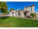 Two-story house with a large front yard, landscaping, and a three-car garage at 8478 W Lewis Ave, Phoenix, AZ 85037