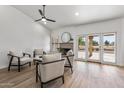 Living area with hardwood floors, fireplace and sliding glass doors at 9447 W Tonto Ln, Peoria, AZ 85382