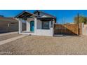 Charming bungalow with a teal door and gravel yard at 1014 S 2Nd St, Phoenix, AZ 85004