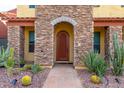 Front entrance with stone archway and wooden door at 11607 N 12Th Ter, Phoenix, AZ 85020