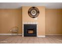 Living room fireplace with a wall-mounted clock at 11640 N 51St Ave # 204, Glendale, AZ 85304