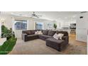 Open concept living room and kitchen with sectional sofa at 1409 E Harvest Rd, San Tan Valley, AZ 85140