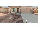 Front yard view of charming house with attached garage at 17449 W El Caminito Dr, Waddell, AZ 85355
