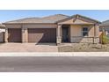 Charming single-story home with a two-car garage and a neatly paved driveway at 17636 W Pierson St, Goodyear, AZ 85395