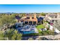 Luxury home with a large backyard, pool, and outdoor kitchen at 18391 N 97Th Pl, Scottsdale, AZ 85255