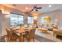 Inviting living room with stylish furniture, a dining table, and natural light from the backyard view at 2611 W Trapanotto Rd, Phoenix, AZ 85086