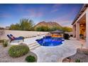 Inviting pool and spa with a covered patio and mountain views at 26475 N 106Th Way, Scottsdale, AZ 85255