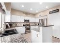 Spacious kitchen with granite counters and stainless steel appliances at 4338 E Woodridge Dr, Phoenix, AZ 85032