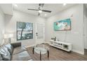Bright living room boasts modern furnishings, sleek flooring, and a ceiling fan for added comfort at 475 N 9Th St # 115, Phoenix, AZ 85006