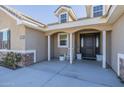 Inviting front porch with rocking chair and dark door at 4789 E Horse Mesa Trl, San Tan Valley, AZ 85140