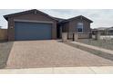 Charming single-story home with a brick driveway and a well-manicured front yard at 4807 N 177Th Ln, Goodyear, AZ 85395