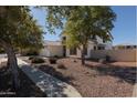 Two-story house with mature trees and a landscaped yard at 8912 S 40Th Dr, Laveen, AZ 85339