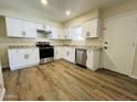 Modern kitchen with white cabinets and stainless steel appliances at 1005 W Anderson Dr, Phoenix, AZ 85023