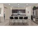 Modern kitchen with island, dark cabinets, and granite counters at 10815 S 175Th Dr, Goodyear, AZ 85338