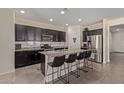 Modern kitchen with dark cabinetry, granite counters, and island at 10815 S 175Th Dr, Goodyear, AZ 85338