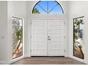 Bright entry with white double doors and arched window at 12286 N 86Th Pl, Scottsdale, AZ 85260