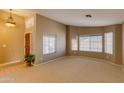 Bright living room with large windows and carpeted floor at 12465 N 71St Ave, Peoria, AZ 85381