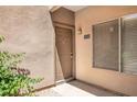 Apartment entryway with brown door and window at 14145 N 92Nd St # 1052, Scottsdale, AZ 85260