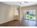 Living room with dark hardwood floors and sliding glass door to patio at 14145 N 92Nd St # 1052, Scottsdale, AZ 85260