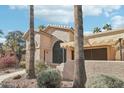 Tan stucco house with arched entryway, walkway, and covered patio at 14300 W Bell Rd # 353, Surprise, AZ 85374