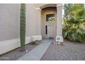 Front entry with walkway, mature cactus, and neutral color scheme at 14971 W Desert Hills Dr, Surprise, AZ 85379