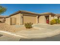 Tan colored house with a two-car garage and a gate at 1840 S Vista Rd, Apache Junction, AZ 85119