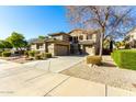 Two story house with large driveway and landscaping at 21932 S 185Th Way, Queen Creek, AZ 85142