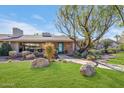 Mid-century modern home with a landscaped yard and walkway at 245 W Berridge Ln, Phoenix, AZ 85013
