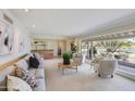 Bright living room with large picture window, neutral tones and a stylish bar area at 245 W Berridge Ln, Phoenix, AZ 85013