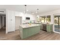 Stylish kitchen with granite island, white cabinets, and stainless steel appliances at 3046 W Palmaire Ave, Phoenix, AZ 85051