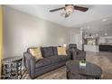 Open living area showcasing a gray sectional sofa and views into the kitchen at 4356 E Coconino St, Phoenix, AZ 85044