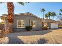 Charming single story home with a well-maintained front yard and gravel driveway at 4939 E Paradise Dr, Scottsdale, AZ 85254