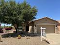 Charming single-story home featuring a well-manicured desert landscape and inviting front porch at 5028 S Peachwood Dr, Gilbert, AZ 85298