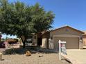Charming single-story home featuring a well-manicured desert landscape and inviting front porch at 5028 S Peachwood Dr, Gilbert, AZ 85298