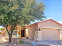 Charming single-story home with a well-manicured front yard and two car garage at 5028 S Peachwood Dr, Gilbert, AZ 85298