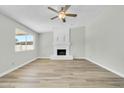 Living room with fireplace and wood-look flooring at 7357 W Canterbury Dr, Peoria, AZ 85345