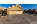 Two-story house with a three-car garage and nicely landscaped yard at 1212 E Butler Dr, Chandler, AZ 85225