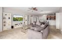 Spacious living room with gray sofas, built in shelving and a large TV at 1844 S 238Th Ln, Buckeye, AZ 85326