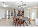 Bright dining room featuring a modern chandelier and views into the living area at 18611 N 22Nd St # 2, Phoenix, AZ 85024